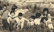 Amos family children with their uncle's wife Ester and cuisines in Musrara, 1960